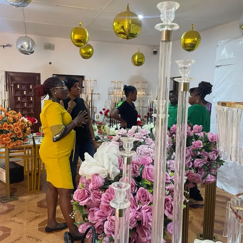 Tall crystal stands of pink and white roses arranged in the training room