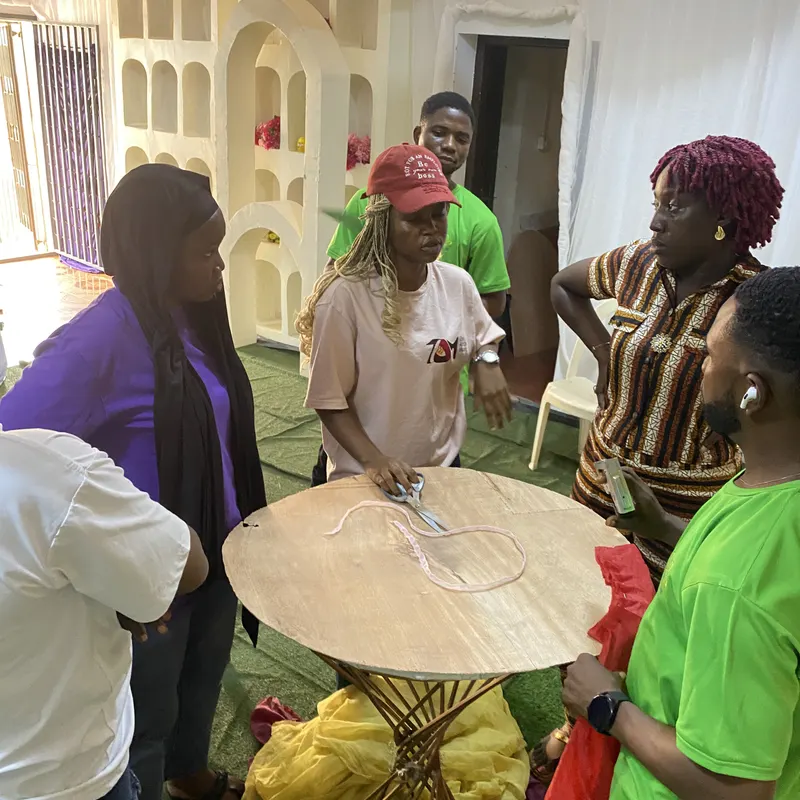 Trainees dressing a round table during a practical decor session