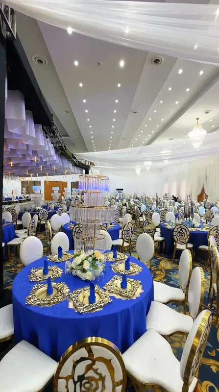 Royal blue and gold banquet tablescape with tiered crystal candelabras at a celebration of life