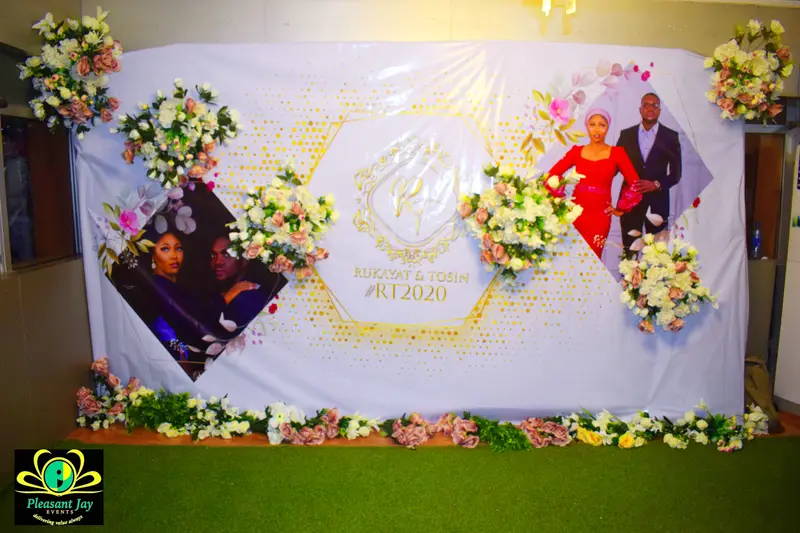 Gold monogram photo backdrop styled for a wedding celebration
